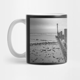 Wooden sea defences at low tide Mug